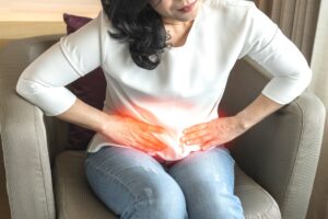 Woman experiencing abdominal pain from a hernia